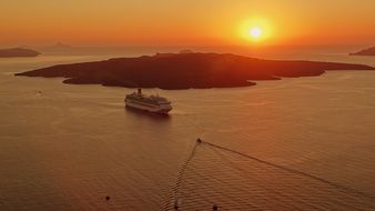 cruise liner near Santorini at sunset