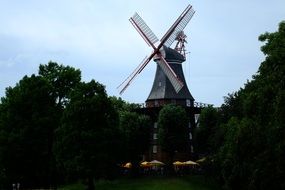 windmill near green trees