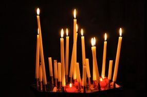 a lot of long candles in church