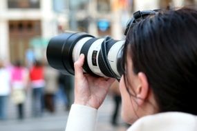 girl with a professional camera on the background of the street