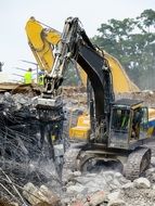 demolition of a building by excavator