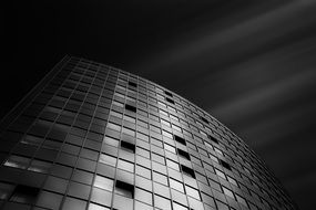 facade of a large hotel in black and white image at night