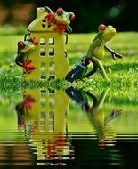 toy house and frogs on the water