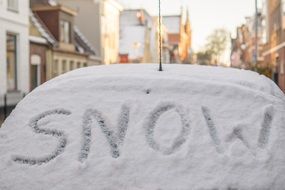 inscription on the snow by car
