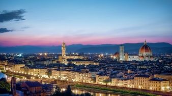 pink sunset over a city in Tuscany, Italy