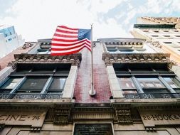 American flag attached to the facade of the building