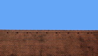 Brown roof of the house and blue sky
