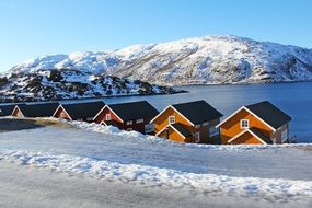Fisherman cabins on a snowy lake bank