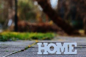 Home, white word on pavement