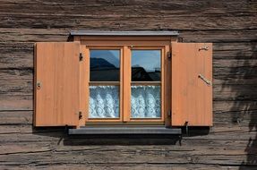 Window with wooden shutters in the house