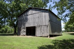 wooden gray barn in the garden