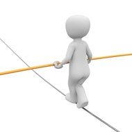 man with yellow stick in his hand walking on a tightrope