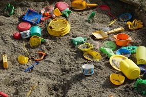 multi-colored children's toys in the sandbox