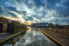 cloudy twilight over a river in wroxham village