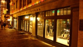 cityscape of glowing shop windows at night