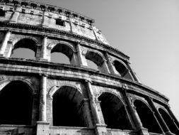 black and white photo of the wall of the coliseum in rome