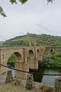 Romanesque bridge has architectural value of UNESCO on green landscape