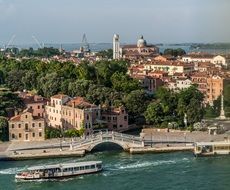 cityscape with boat on canal and bridge, Italy, Venice