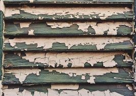 the shutters on the window with shabby paint