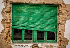 green wooden Window in Abandoned House wall