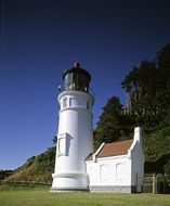 white lighthouse on the coastline in Oregon