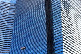 Window cleaners on a skyscraper wall, singapore