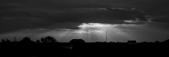 rays of the sun behind dark clouds