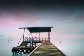 photo of a wooden jetty against the backdrop of a purple sunset in Queensland