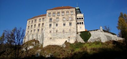 castle museum in poland on a green hill