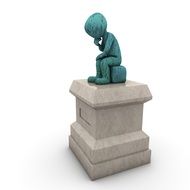 stone sculpture of a man who sits on a chair