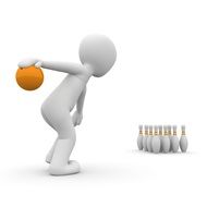 athlete throws the ball at the pins in a bowling alley