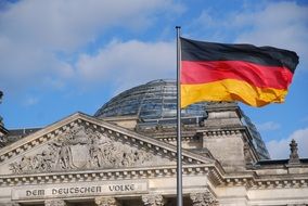 cityscape of German flag near the government building