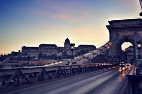 view from the bridge to Budapest castle at sunset