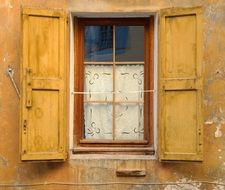 yellow window with shutters in France