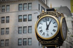 monument with a clock on a city street