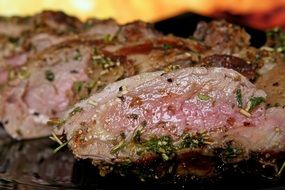 sliced beef ribs with spices on the barbecue