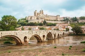 bridge on a river near a church in france