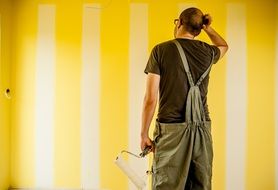 builder near the yellow wall