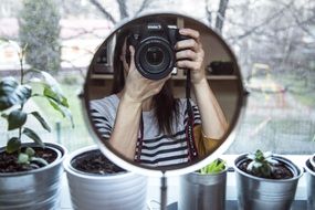 photographer with camera in mirror