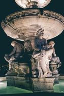 statues near the fountain in budapest at night