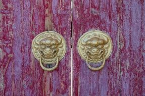 burgundy wooden door and antique gold handles