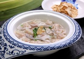 Chinese noodle soup in a ceramic plate