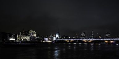 London embankment and bridge across Thames river at Night, england