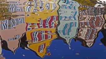 distorted reflection of houses on the water