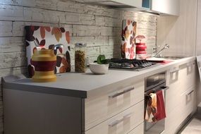 light furniture and stone wall in the kitchen