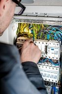 electrician man near the electrical panel