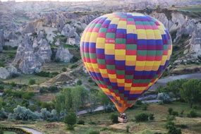 people on colorful hot air Balloon above cave City, turkey