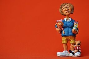 baby-sitter figurine with children and toys in hand