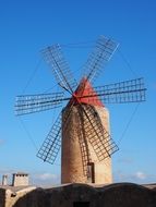 windmill on a hill against a blue sky