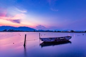 boat on the water against the background of colorful sunset